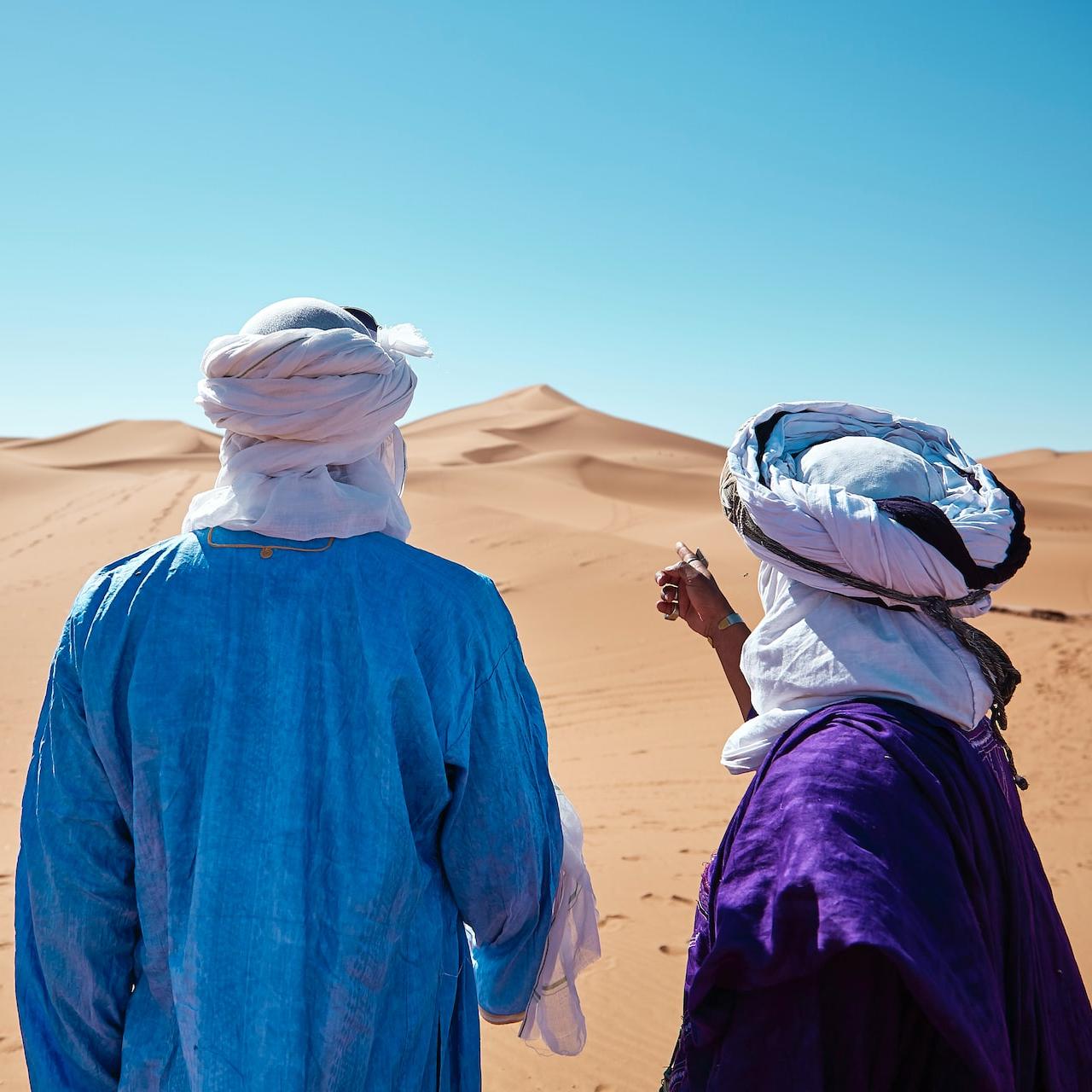 two persons standing on desert